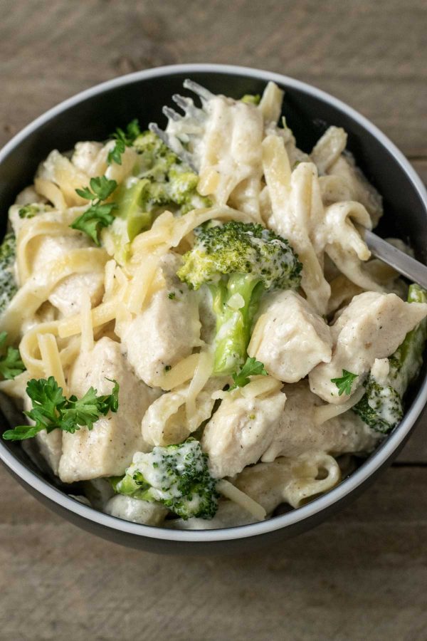 Chicken Fettuccine Alfredo with Broccoli in a bowl with a fork.