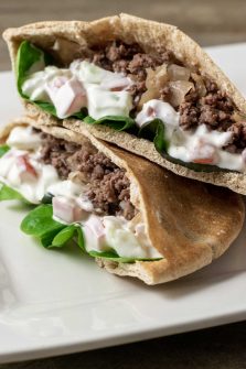 two half Gyro Style Pita Bread Sandwiches on a platter