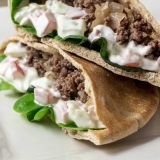 two half Gyro Style Pita Bread Sandwiches on a platter