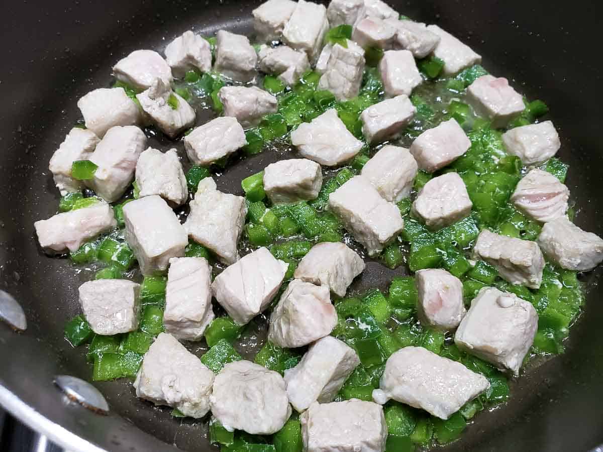 pork and green pepper cooking in a pan