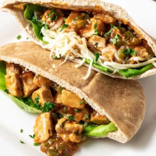 two half Italian Pita Bread Sandwiches on a plate