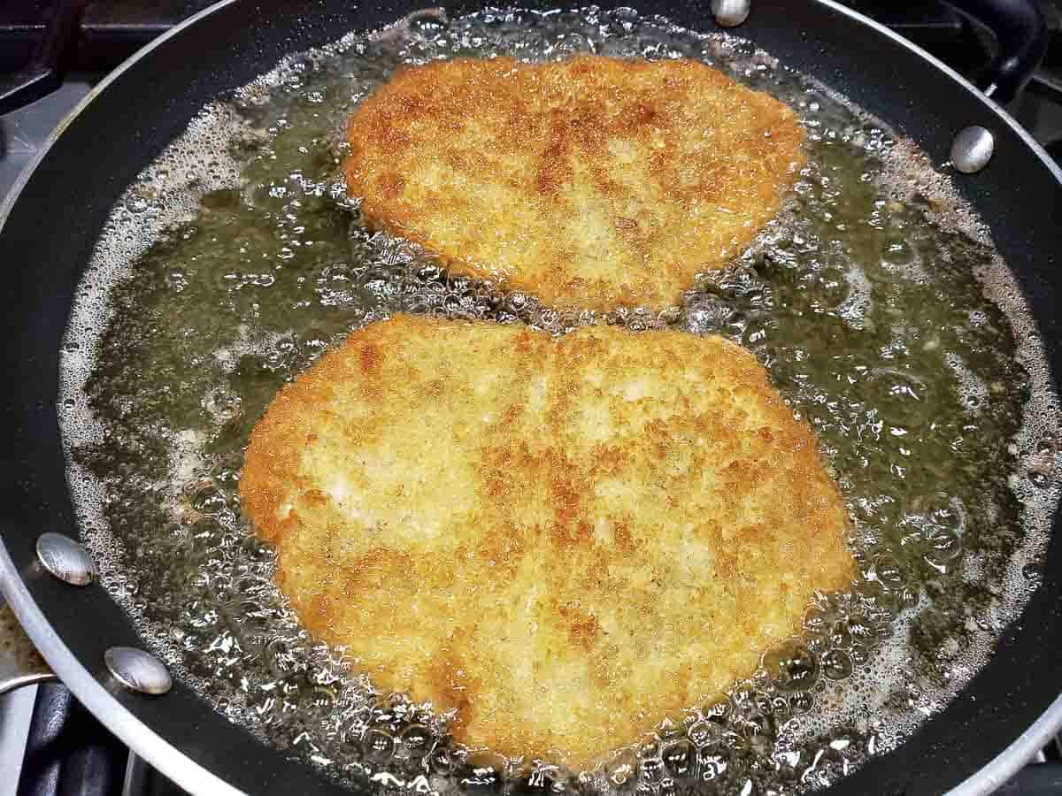 Japanese Pork Cutlet frying in oil in a pan.