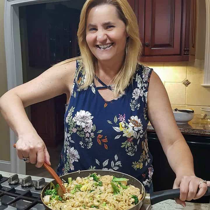 a woman stirring food in a pan