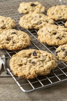 a small batch of oatmeal raisin cookies cooling on a wire rack