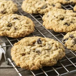 a small batch of oatmeal raisin cookies cooling on a wire rack