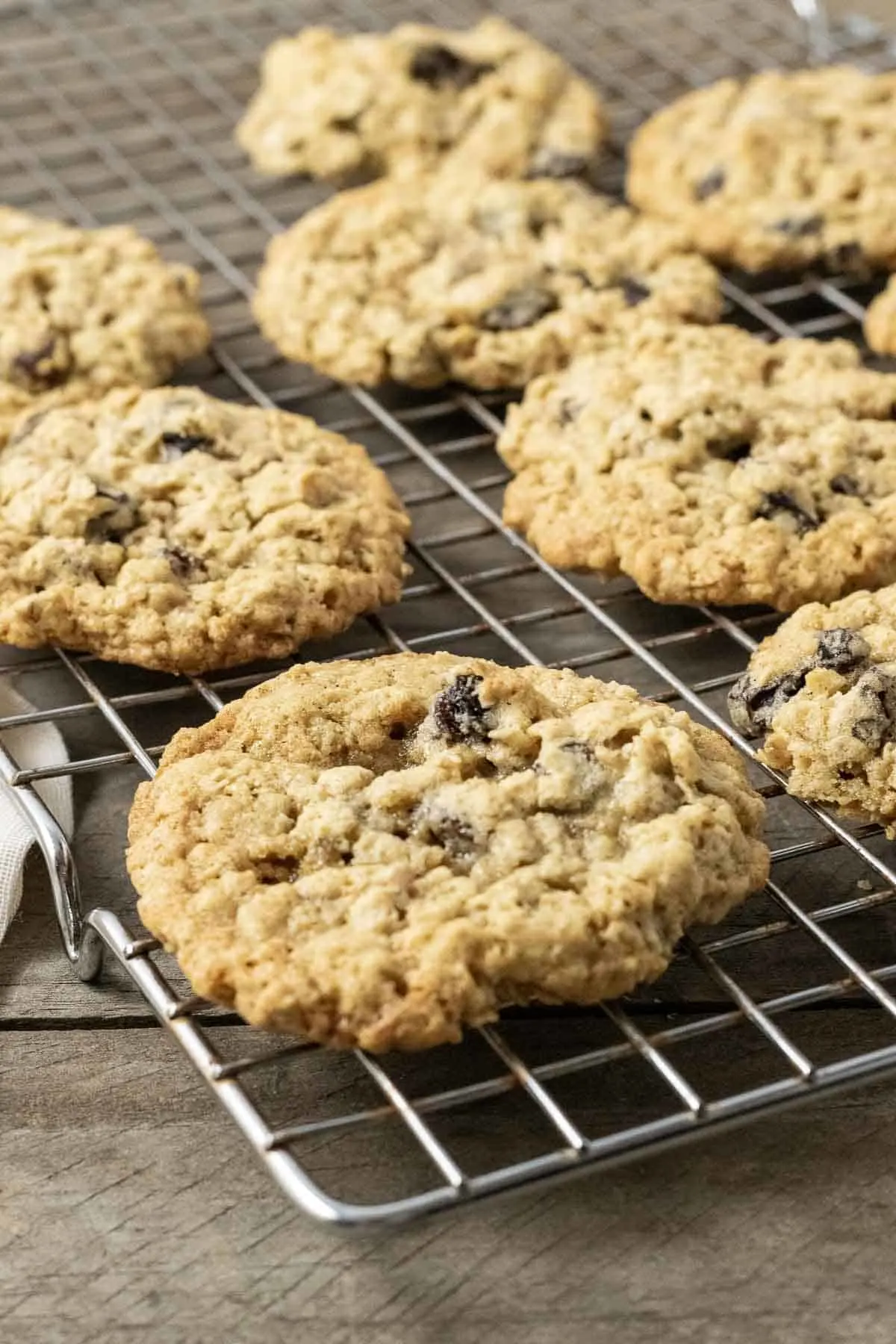 a small batch of oatmeal raisin cookies cooling on a wire rack