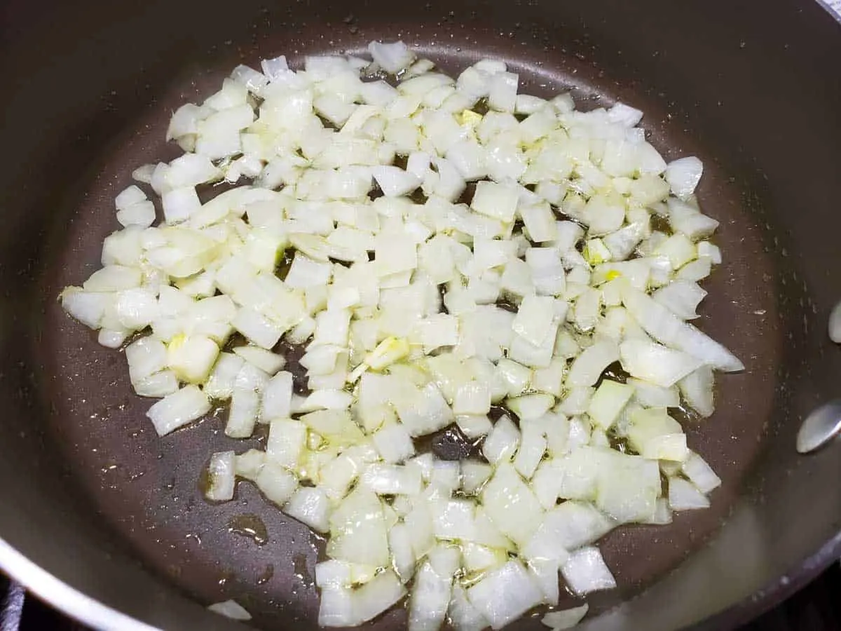 diced onion cooking in a frying pan