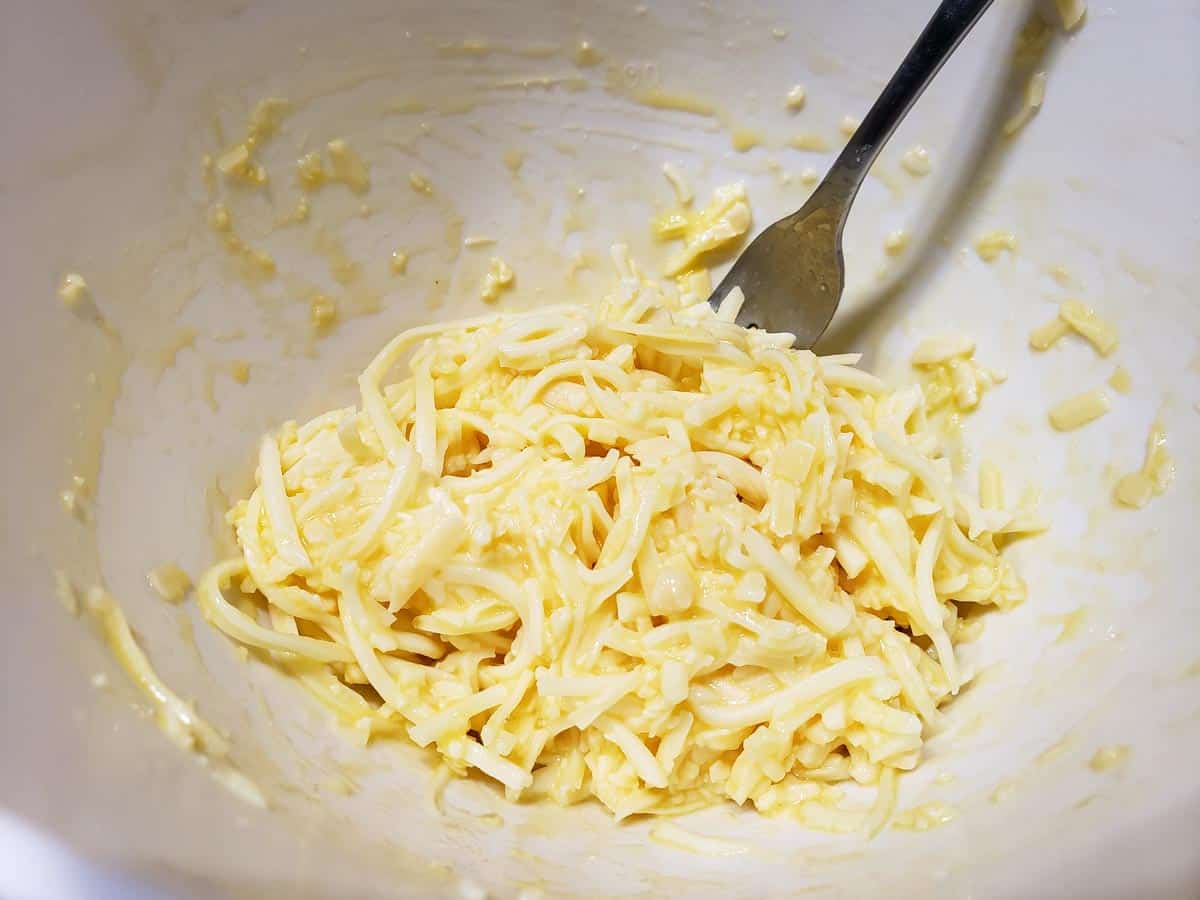 egg, parmesan cheese, and mozzarella mixed in a bowl
