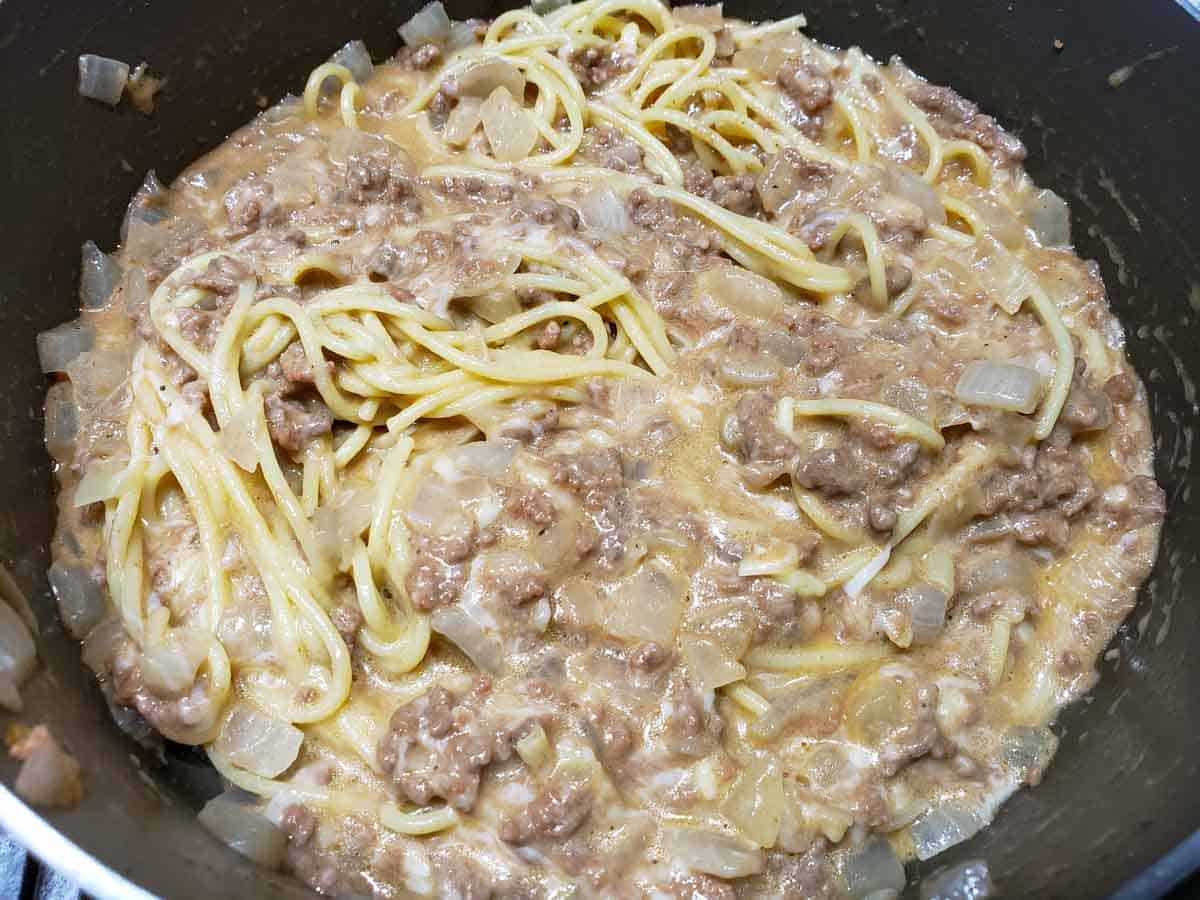 Cheesy Spaghetti in a pan.
