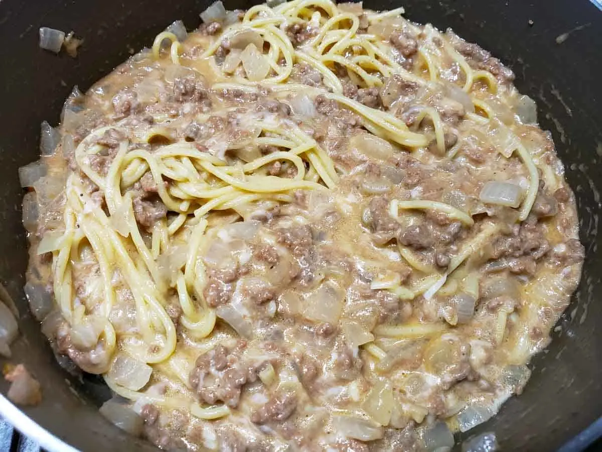 Cheesy Spaghetti in a pan.