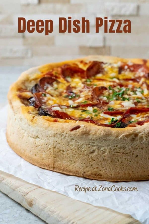 a pizza with very thick and tall crust on a cutting board and text saying deep dish pizza recipe at zonacooks.com.