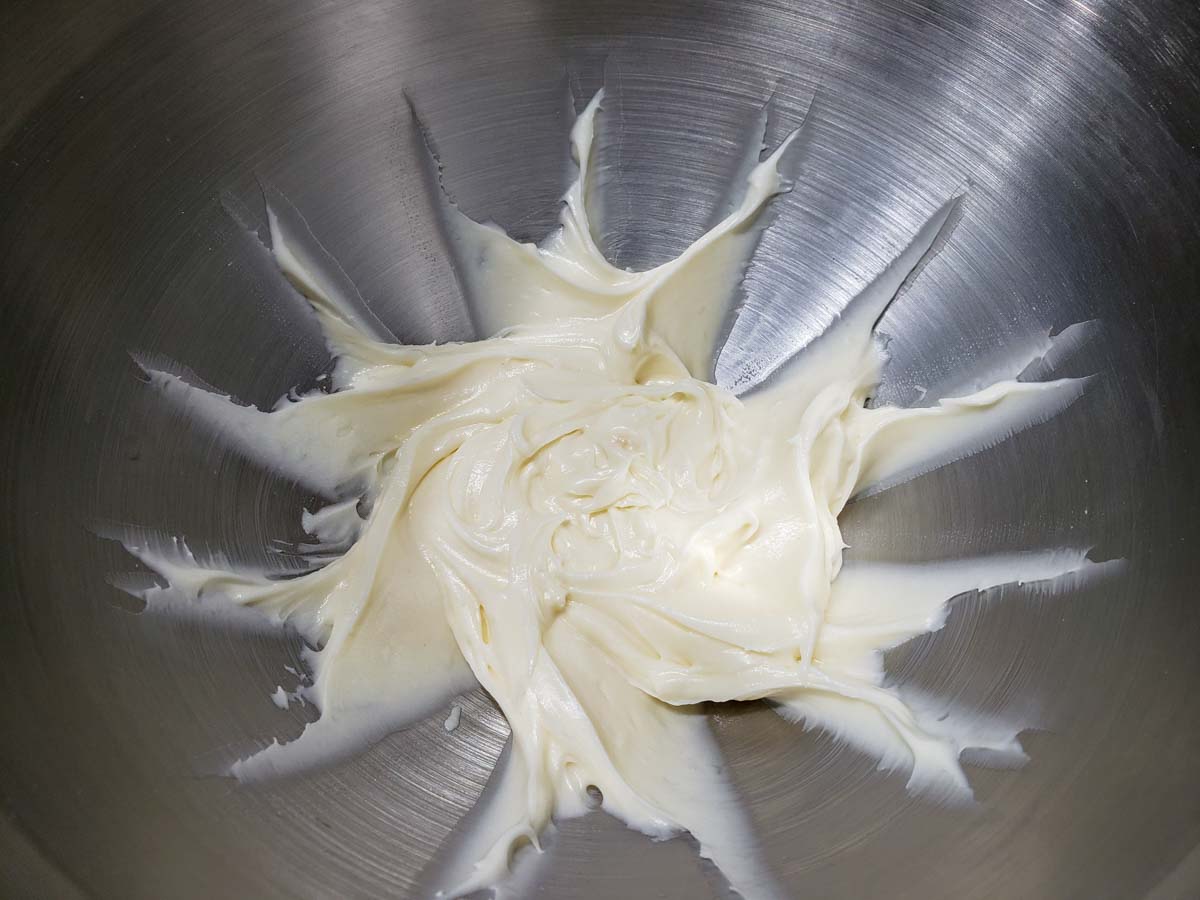white cream cheese frosting mixed in a bowl