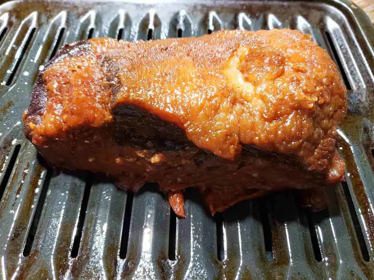 a cooked beef brisket on a broiler pan
