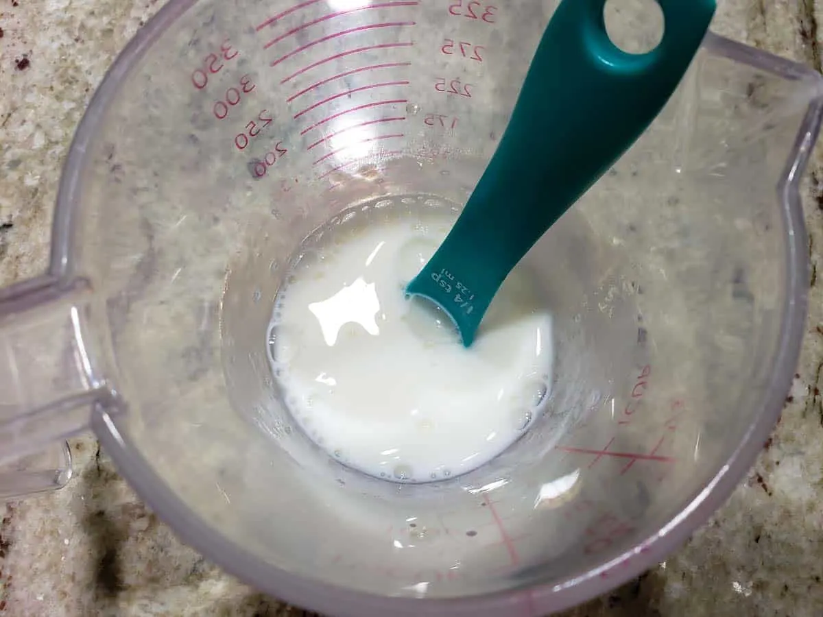 milk and vinegar mixed in a measuring cup