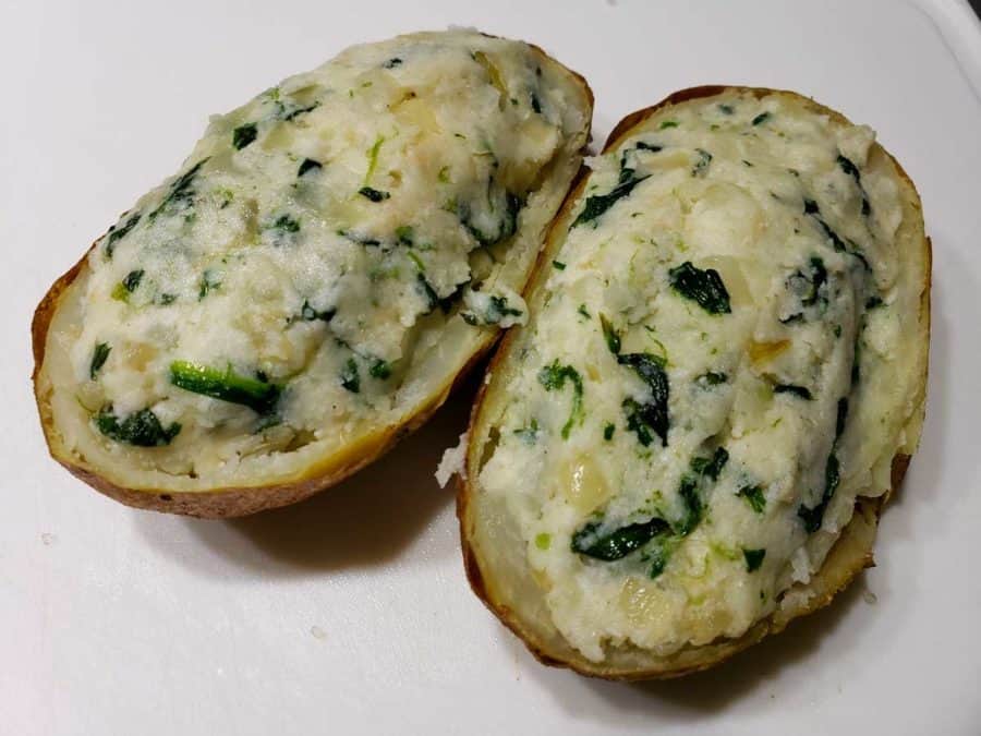 spinach mashed potato mixture stuffed into two potato skins