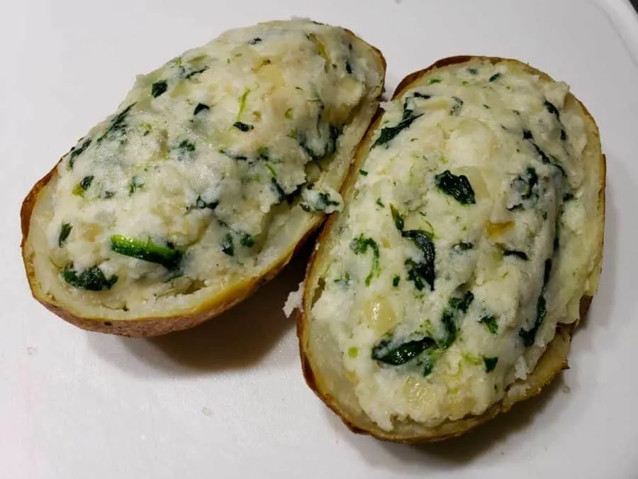 spinach mashed potato mixture stuffed into two potato skins