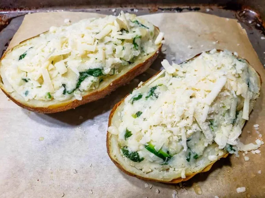 parmesan shreds sprinkled over stuffed potato halves
