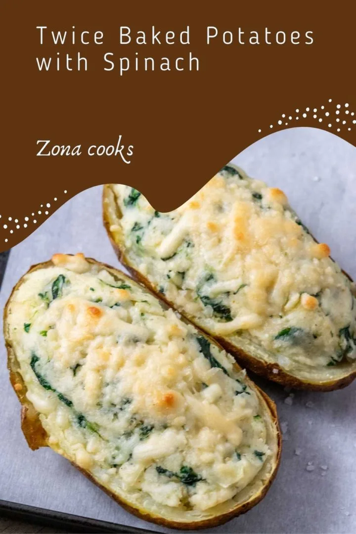 two twice baked potatoes with cream cheese and spinach on a baking sheet.