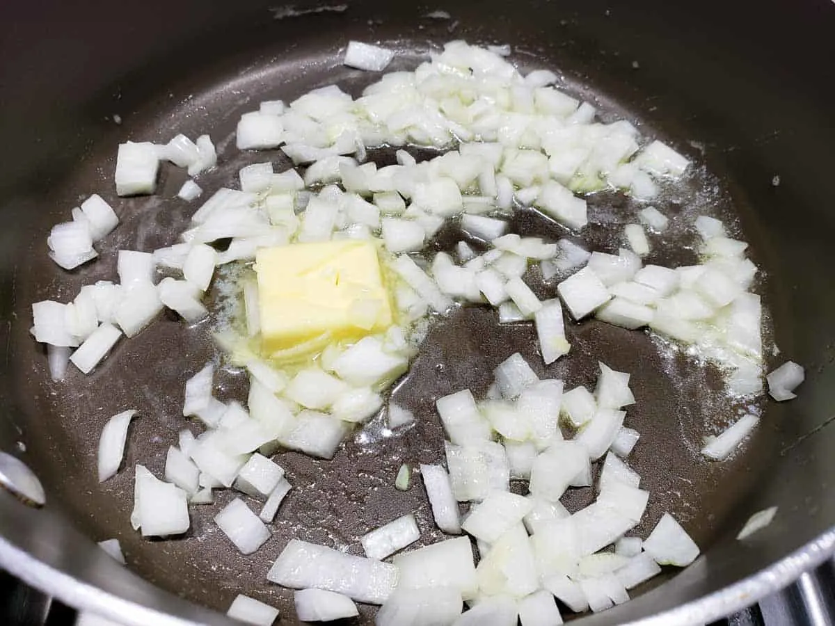 diced onions and butter cooking in a pan