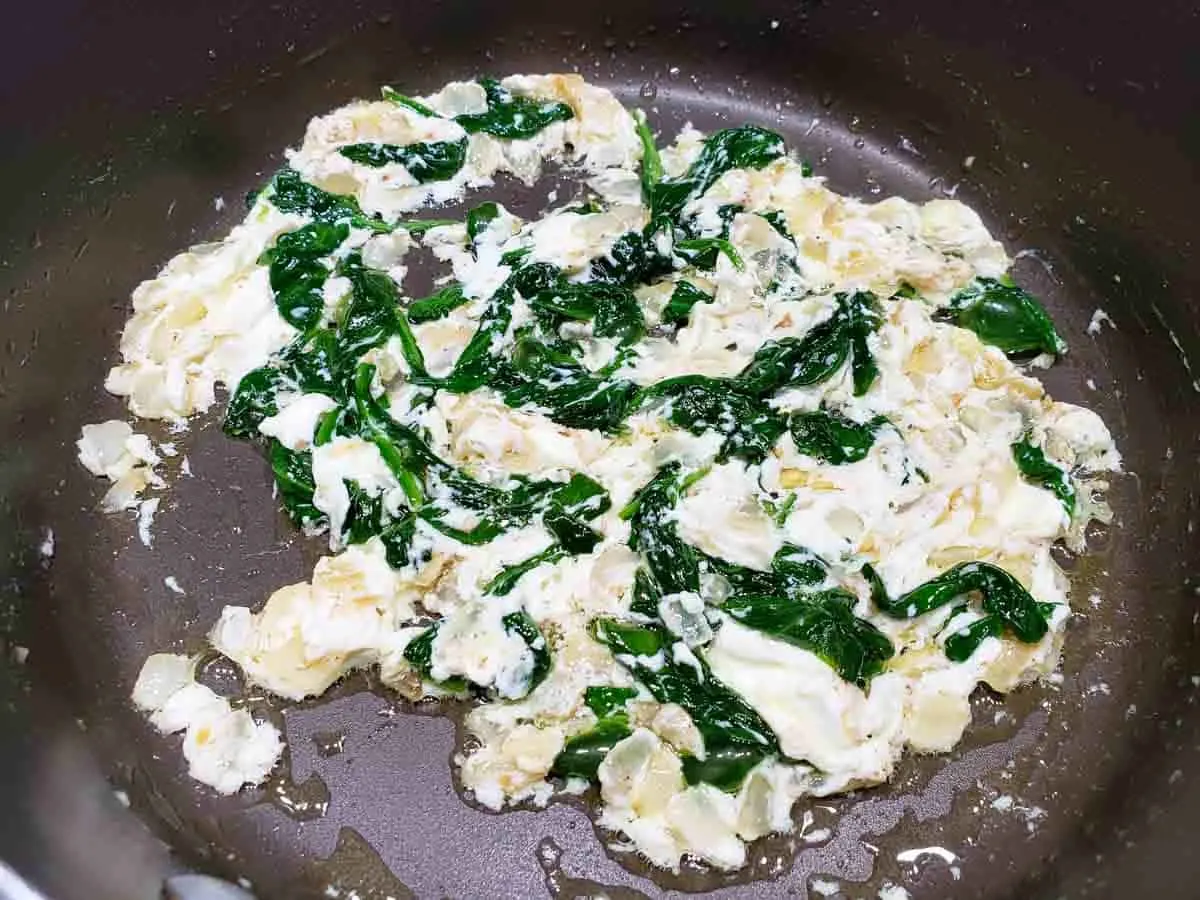 cream cheese melted into a spinach and onion mixture