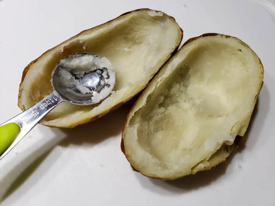 two potato skins with the insides scooped out