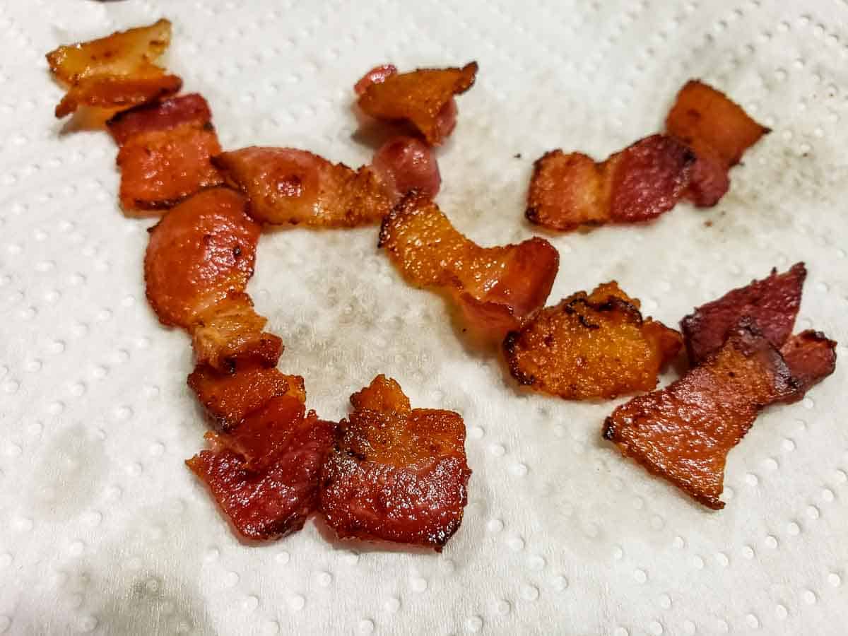 bacon pieces cooling on paper towel