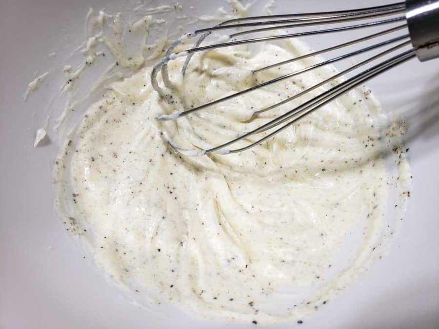 white creamy mayo mixture in a bowl with a whisk