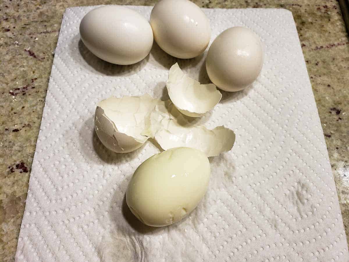 3 unpeeled hard boiled eggs and 1 egg with the shell off