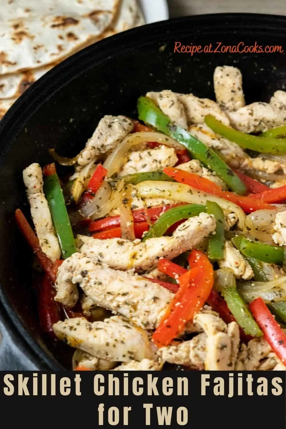 a cast iron skillet filled with sliced green pepper, red pepper, onions, and chicken in homemade fajita seasoning.