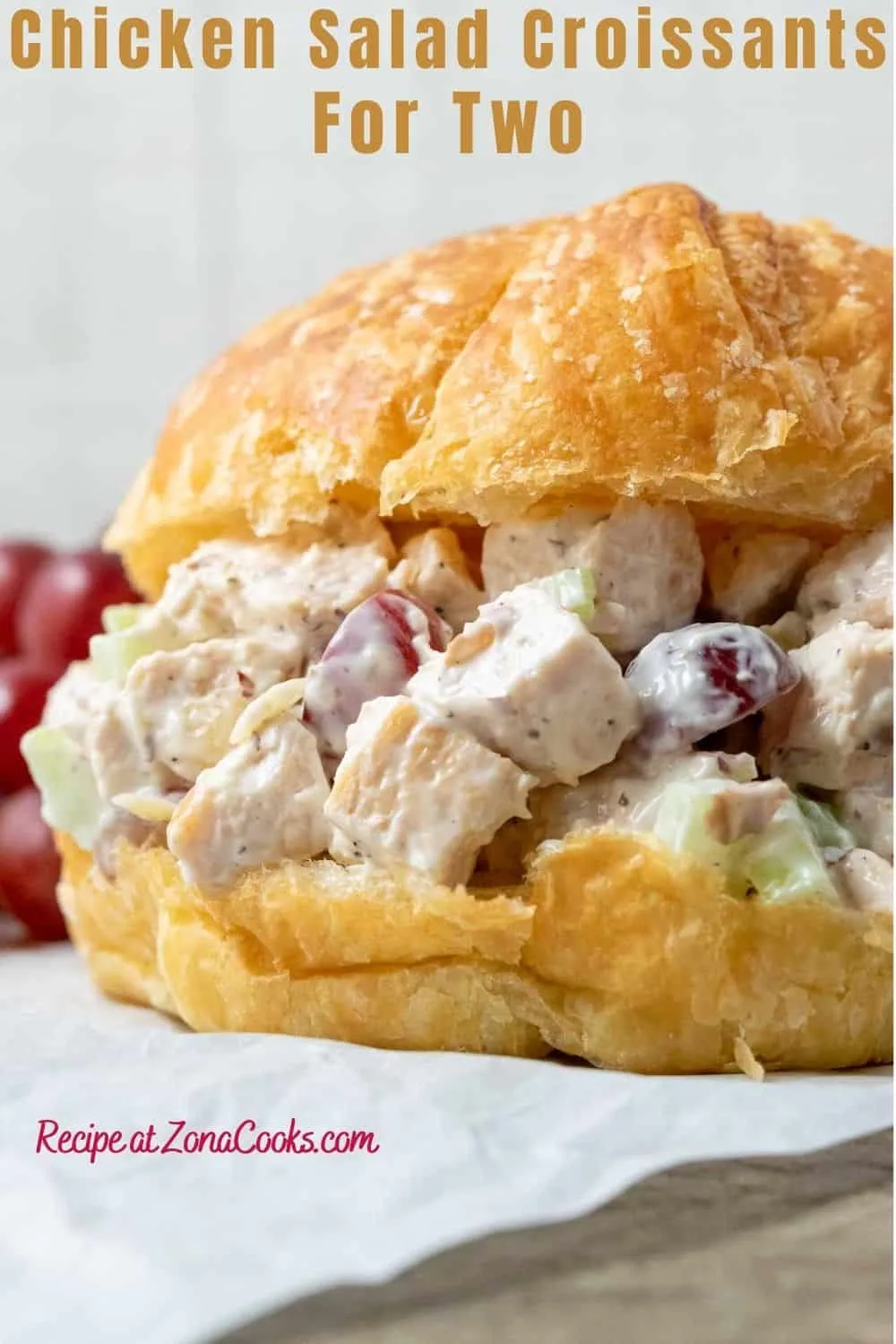 Chicken Salad Croissant with boneless chicken, grapes, almonds, and celery coated in a mayo dressing piled in large buttery croissant rolls and text reading chicken salad croissants for two recipe at zonacooks.com.
