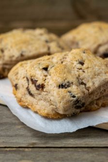 fluffy golden brown scones filled with cinnamon and raisins and topped with coarse sugar