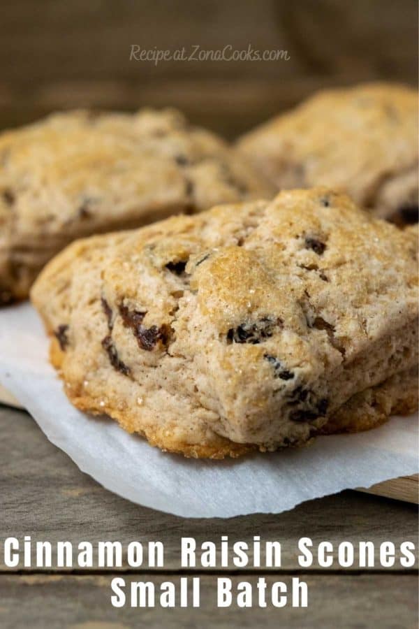 fluffy golden brown biscuits filled with cinnamon and raisins and topped with coarse sugar and text reading recipe at zonacooks.com cinnamon raisin scones small batch