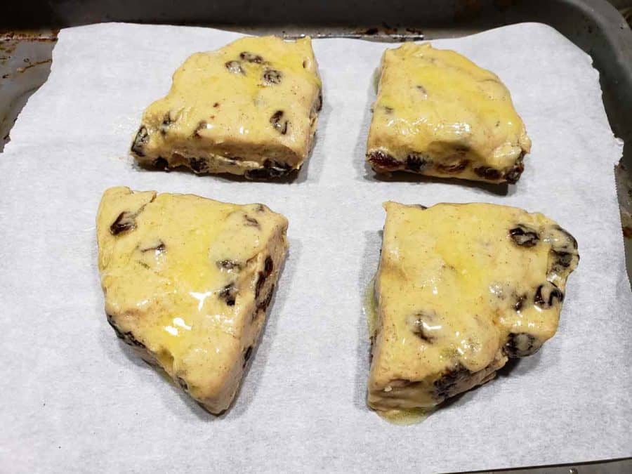 melted butter brushed on top of 4 scone dough triangles