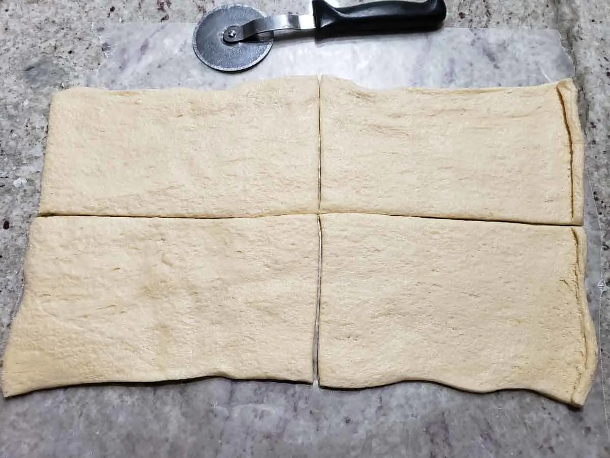 an unperforated crescent dough sheet cut into 4 equal rectangles