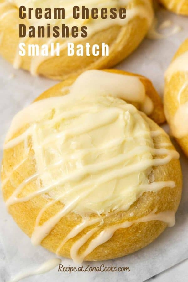 golden brown crescent dough topped with a cream cheese filling in the center and a white creamy glaze drizzle and text reading cream cheese danishes small batch recipe at zonacooks.com