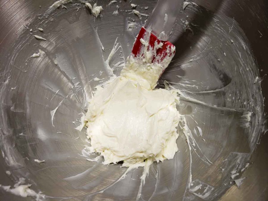 a bowl filled with white cream cheese filling mixture