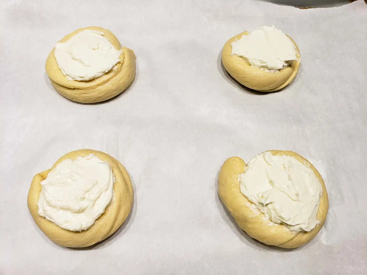 four crescent dough circles filled with cream cheese filling