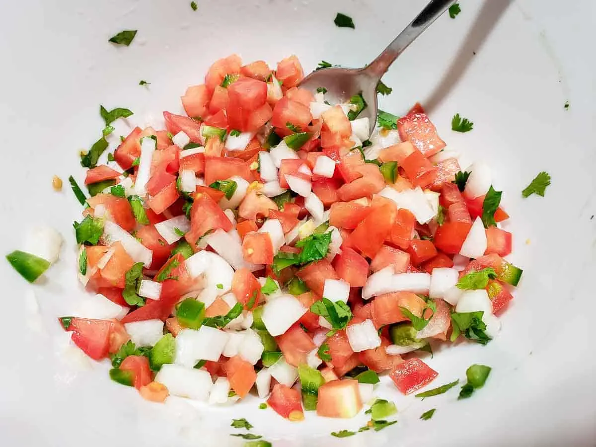 pico de gallo ingredients mixed together in a bowl