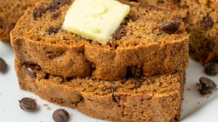 two slices of best chocolate chip zucchini bread topped with butter.