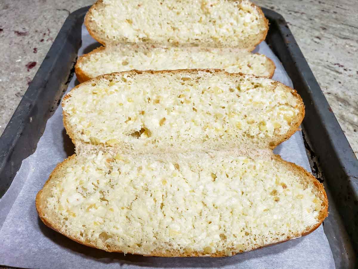 garlic butter spread inside two hoagie rolls.
