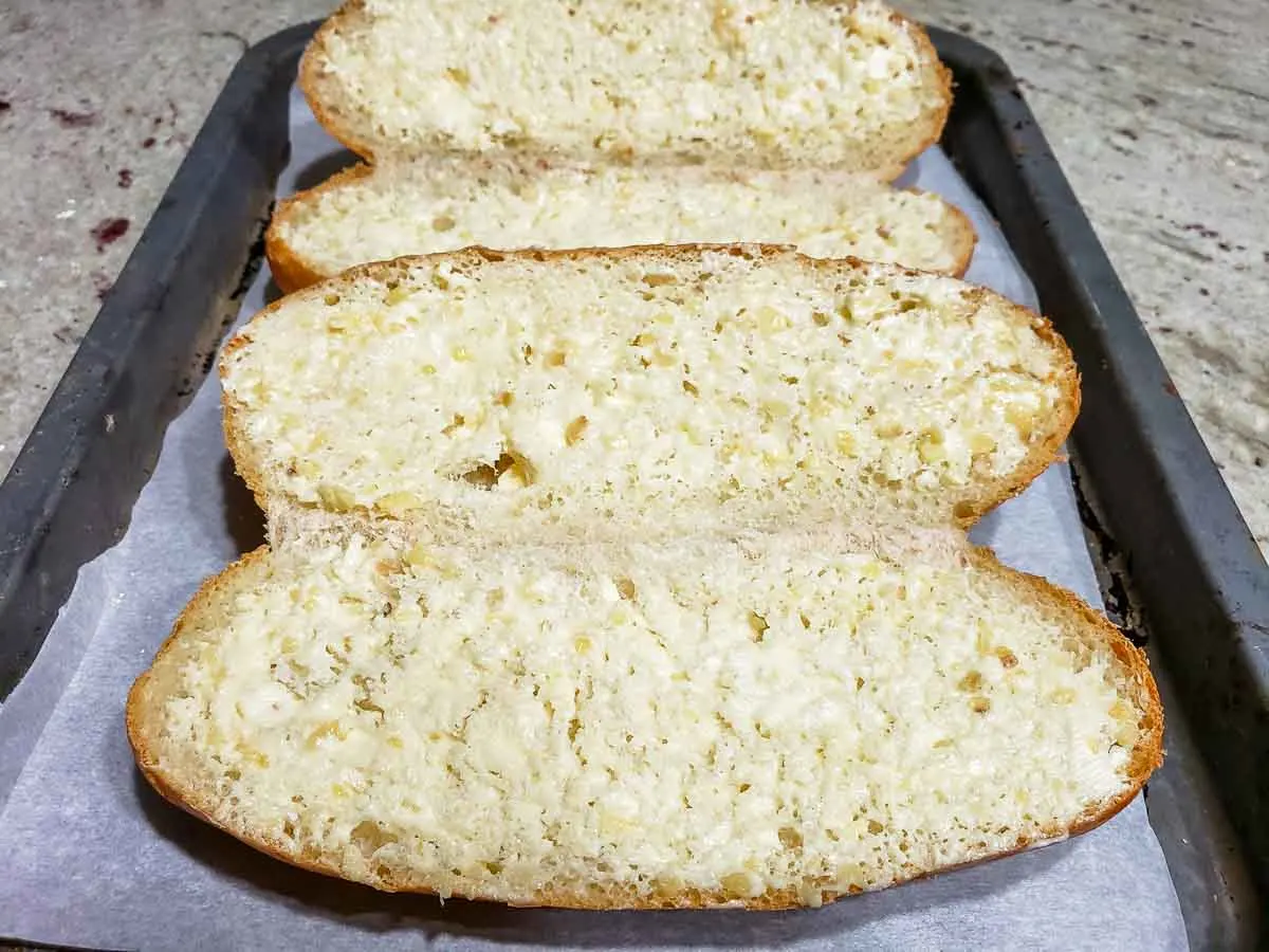 garlic butter spread inside two hoagie rolls.