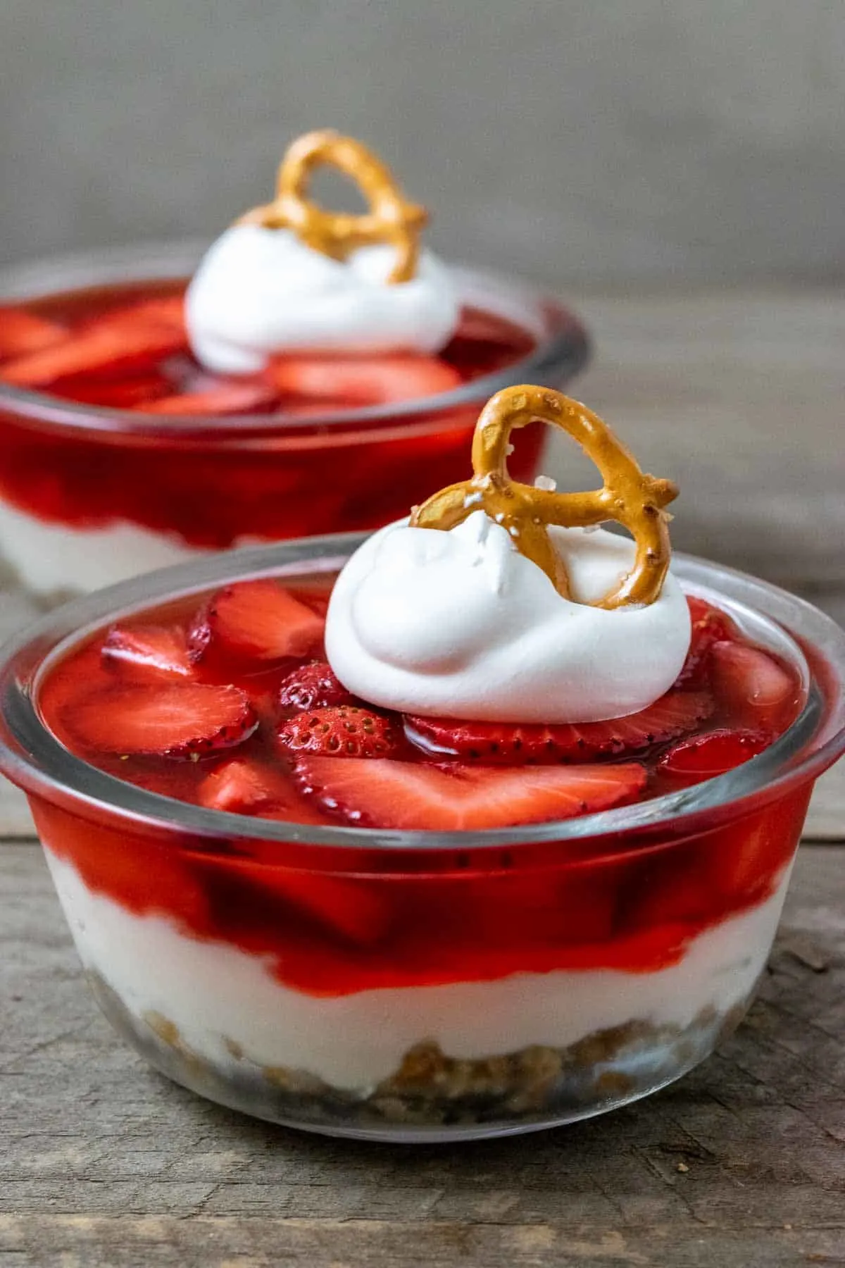 two bowls filled with old fashioned strawberry pretzel salad.