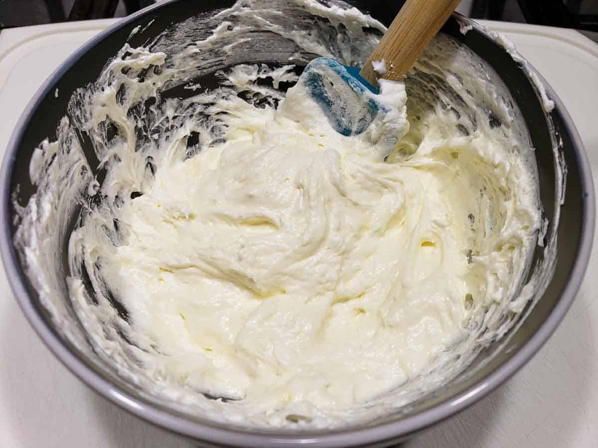 cream cheese mixture and whipped cream mixed together in a bowl.