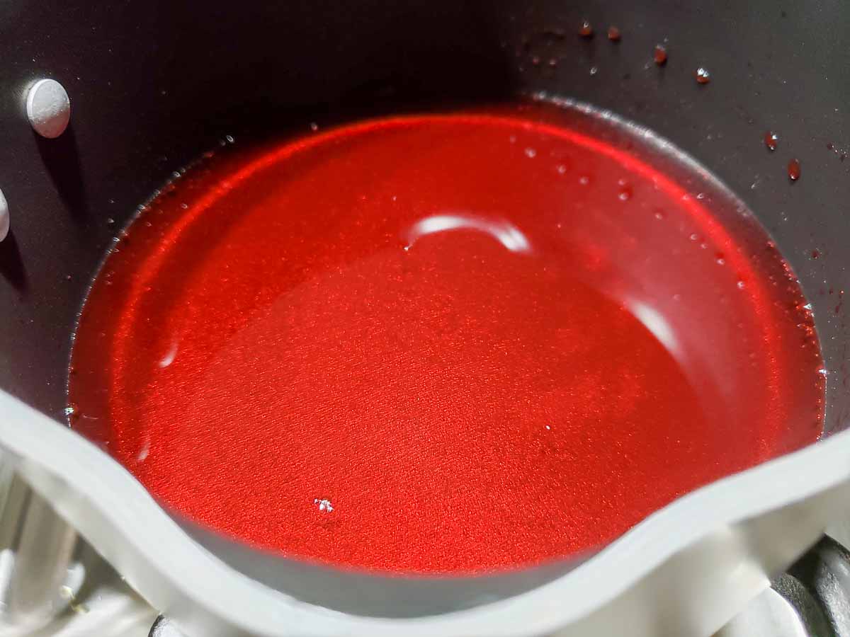 red strawberry jello in a sauce pan.