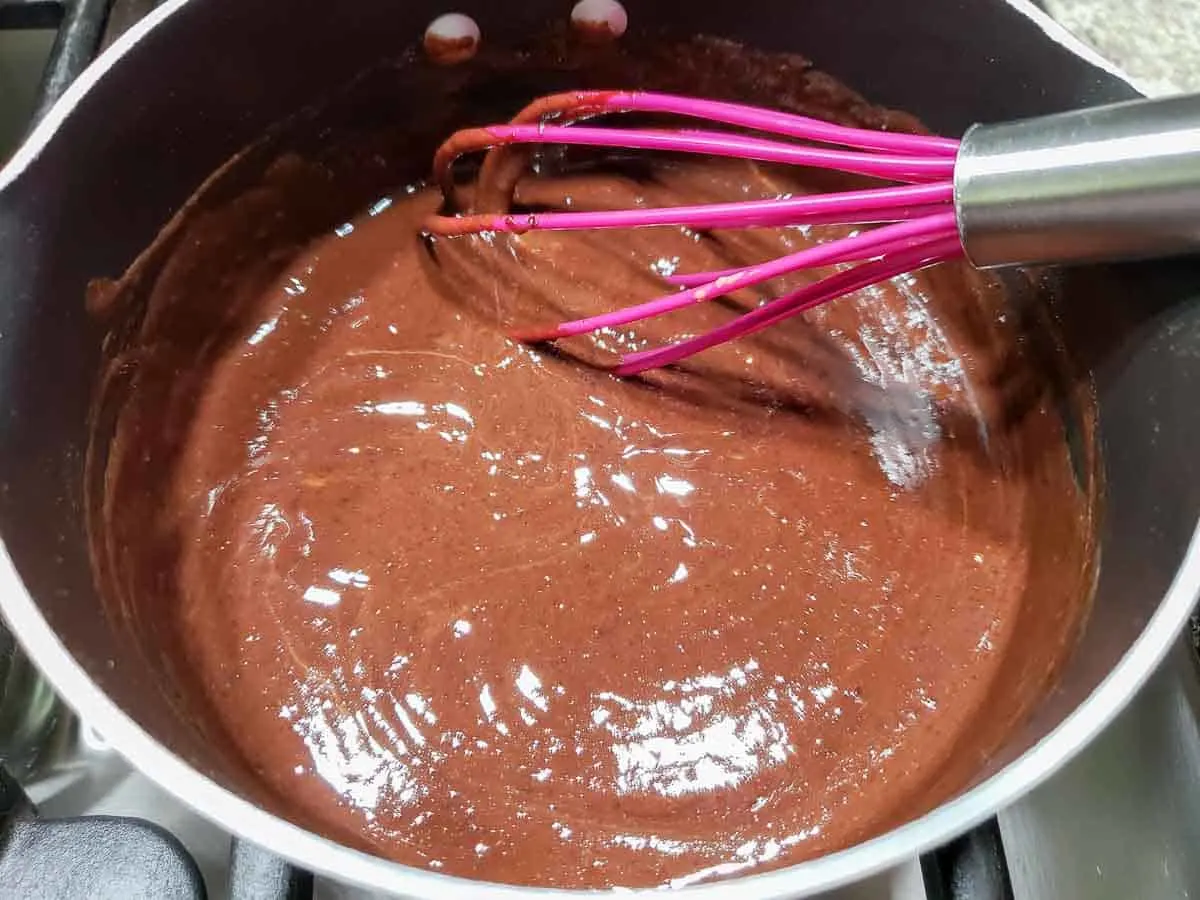 chocolate peanut butter sauce cooking in a sauce pan.