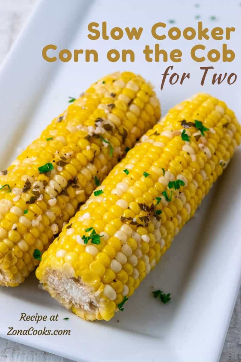 two ears of Crock Pot Corn on the Cob on a plate.