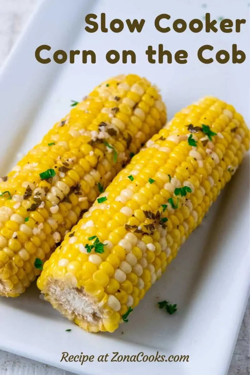 two pieces of Slow Cooker Corn on the Cob on a plate.