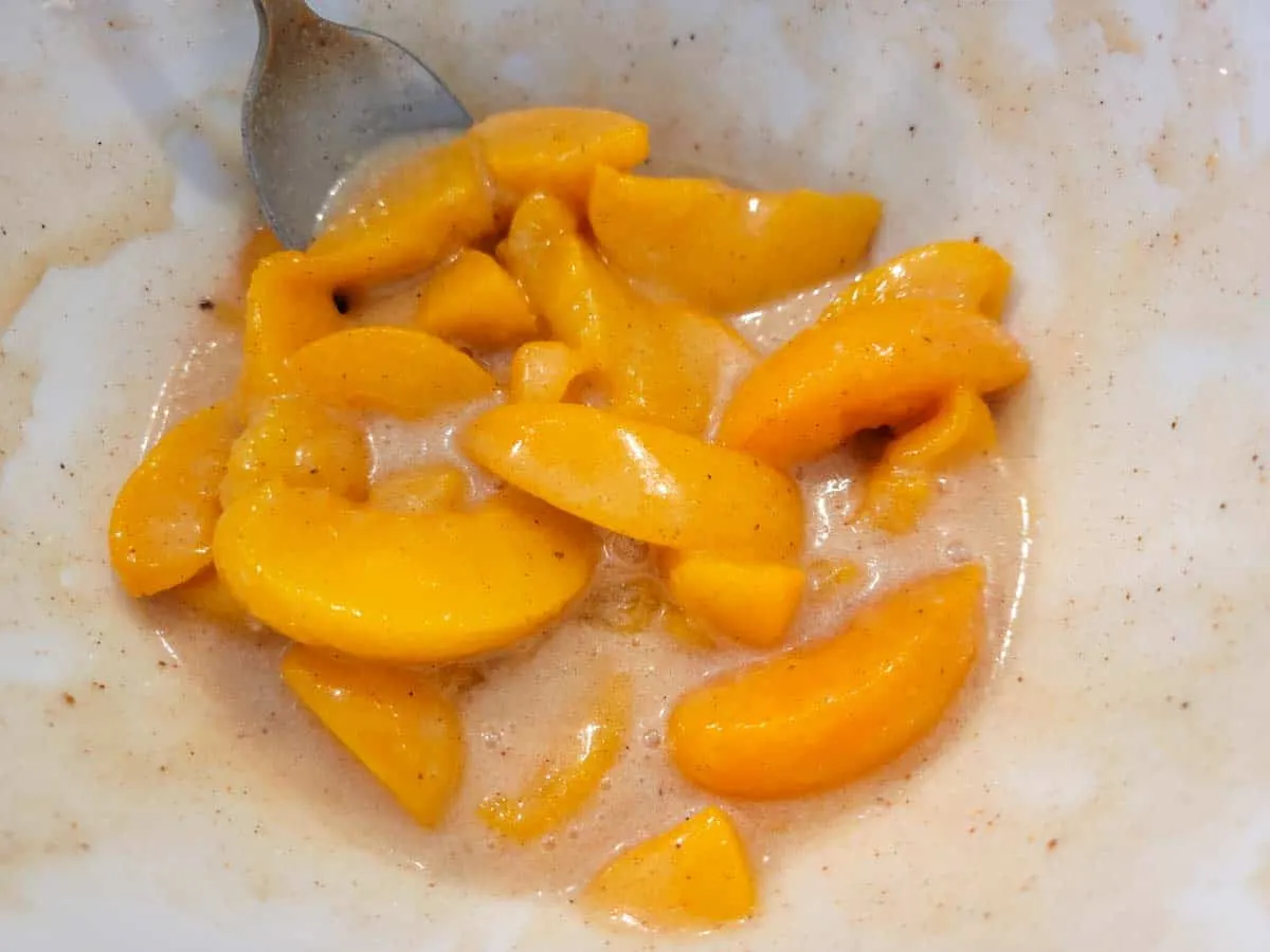 a bowl filled with peach pie filling.