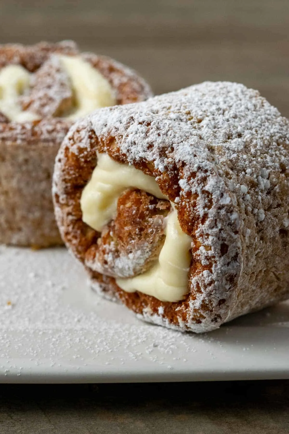 two slices of classic pumpkin roll on a plate.