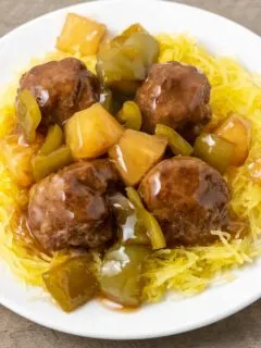 a plate filled with Spaghetti Squash with Hawaiian Meatballs, pineapple, and green peppers.